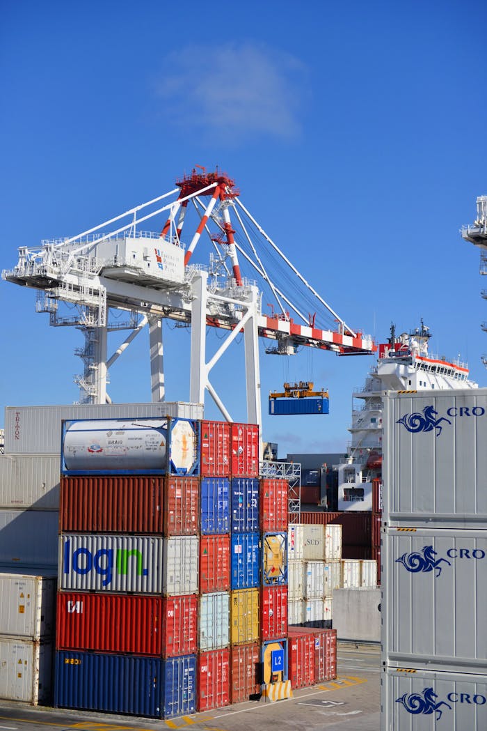 The Art of Drawing Readers In: Your attractive post title goes here Colorful shipping containers stacked in a busy port with cranes overhead.