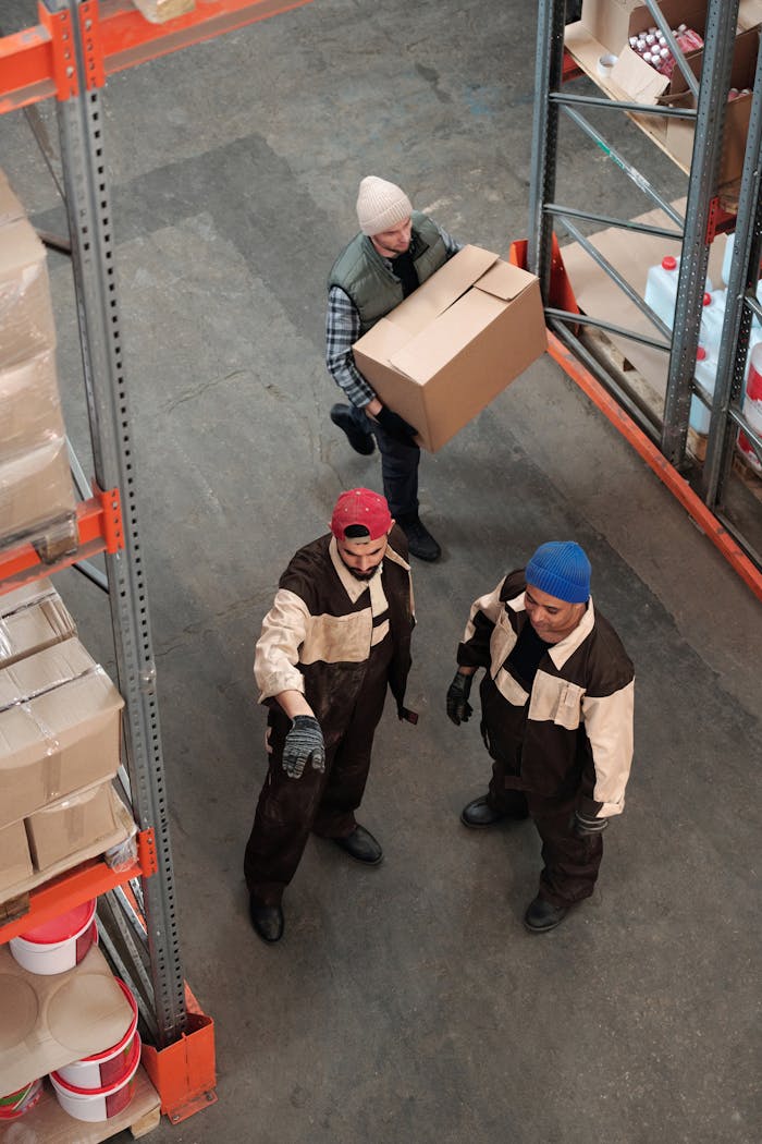 Crafting Captivating Headlines: Your awesome post title goes here Team of workers managing inventory in a warehouse, emphasizing logistics and teamwork.
