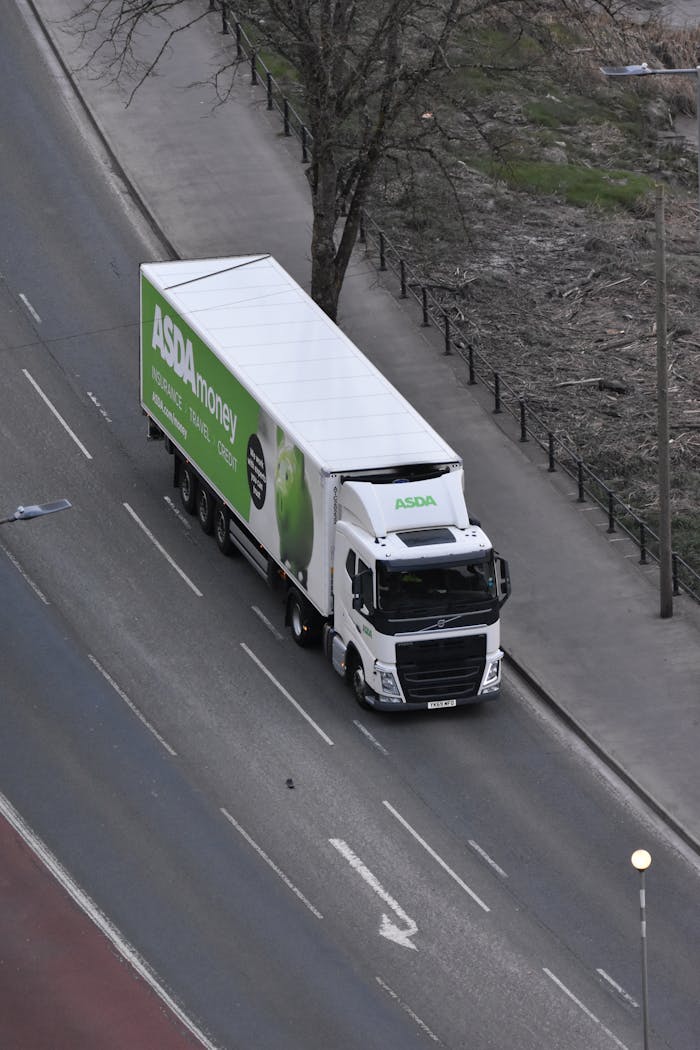 Mastering the First Impression: Your intriguing post title goes here High angle view of an ASDA delivery truck driving on an urban street.